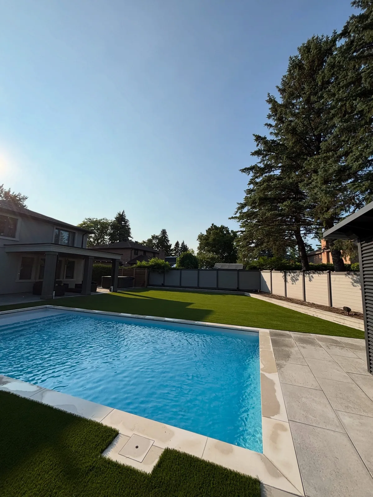 Artificial grass installed around a backyard pool in Newmarket